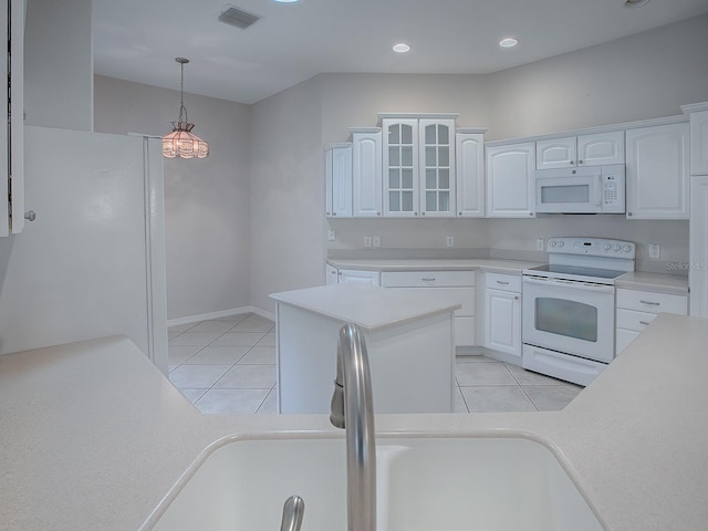 kitchen with white appliances, white cabinets, sink, hanging light fixtures, and light tile patterned floors