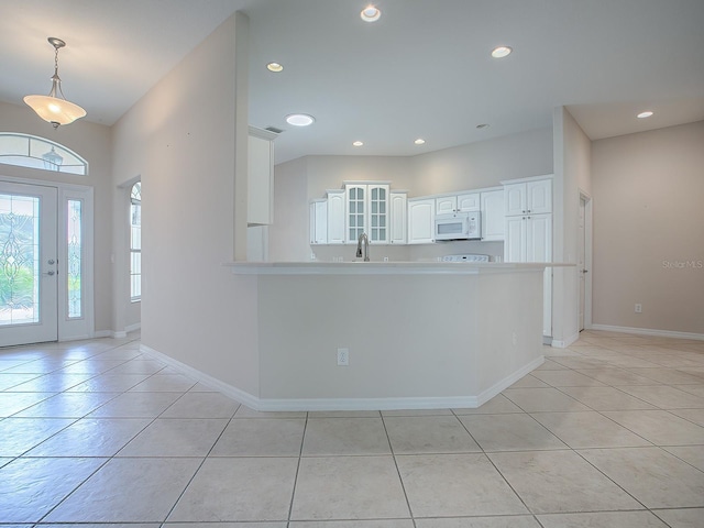 foyer entrance featuring light tile patterned flooring and sink