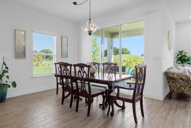 dining area featuring a chandelier and light hardwood / wood-style floors