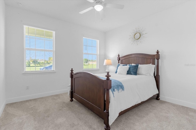 bedroom featuring light carpet and ceiling fan