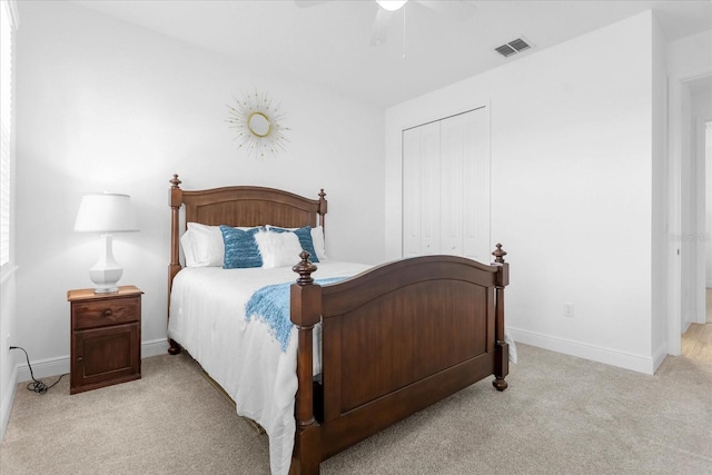 carpeted bedroom with ceiling fan and a closet