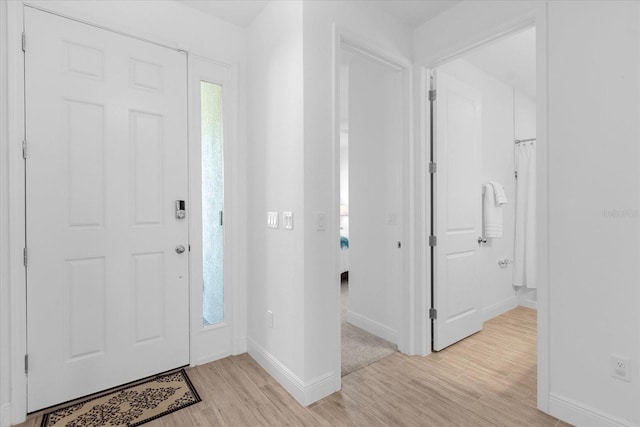 foyer entrance with light hardwood / wood-style flooring