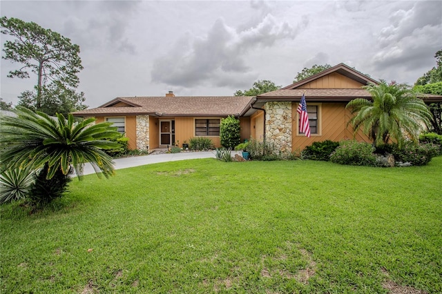 ranch-style house with a front lawn