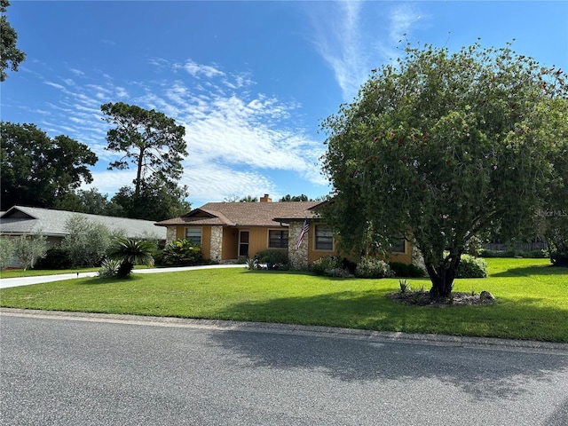 ranch-style home with a front lawn