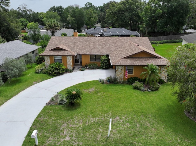 ranch-style home featuring a lanai and a front lawn