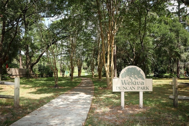 surrounding community featuring a yard and fence