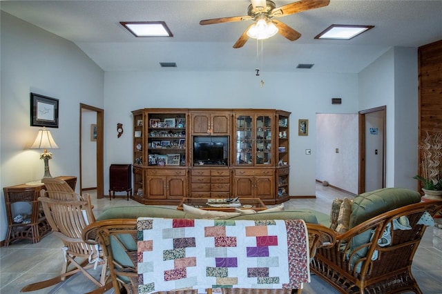 living area featuring vaulted ceiling, ceiling fan, light tile patterned flooring, and visible vents