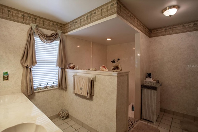 bathroom featuring double vanity, wallpapered walls, and tile patterned floors