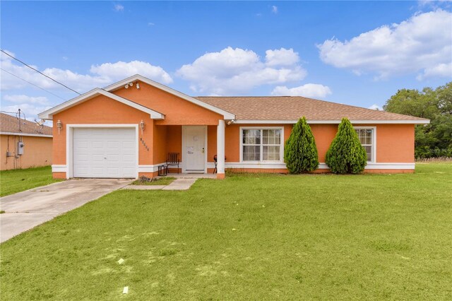 single story home featuring a garage and a front lawn