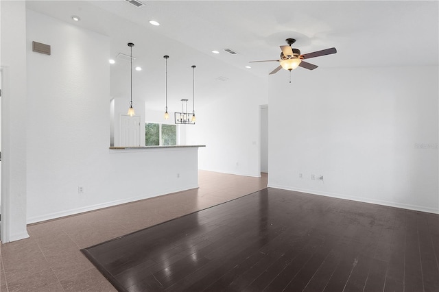 empty room with ceiling fan, hardwood / wood-style flooring, and high vaulted ceiling