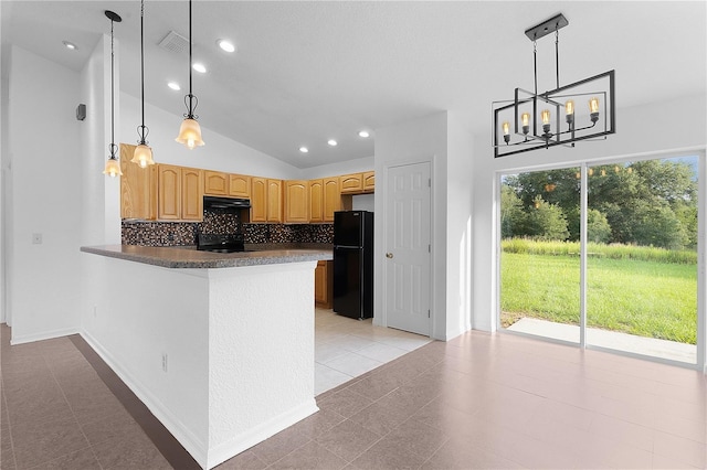 kitchen featuring tasteful backsplash, black refrigerator, extractor fan, pendant lighting, and kitchen peninsula