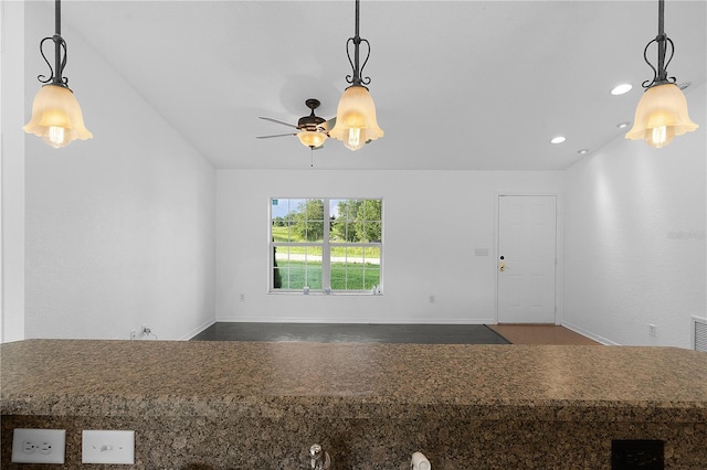 interior space featuring hanging light fixtures and ceiling fan