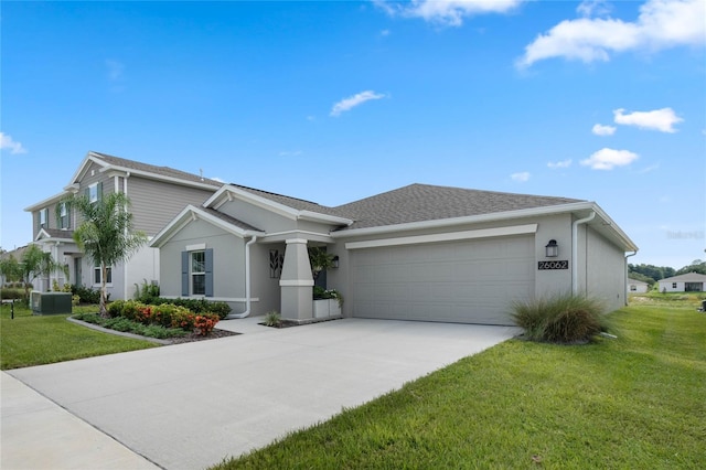 ranch-style home with central AC unit, a garage, and a front yard