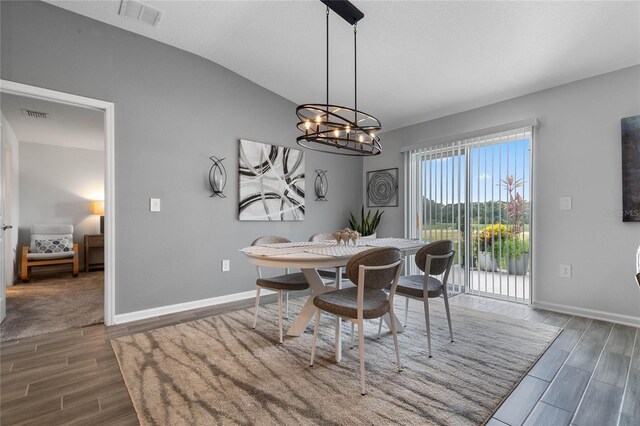 dining space featuring a chandelier and lofted ceiling