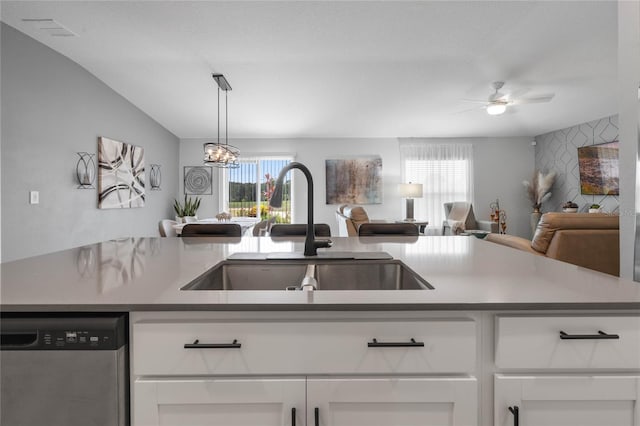 kitchen featuring dishwasher, pendant lighting, white cabinetry, and sink