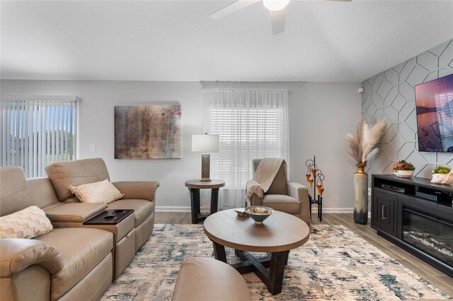 living room with ceiling fan and light wood-type flooring