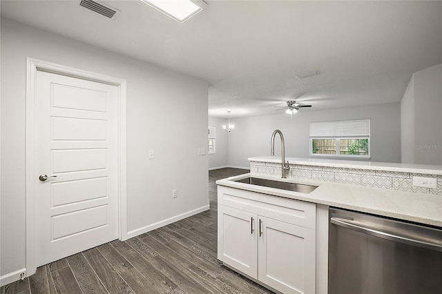 kitchen with ceiling fan with notable chandelier, sink, stainless steel dishwasher, dark hardwood / wood-style floors, and white cabinetry