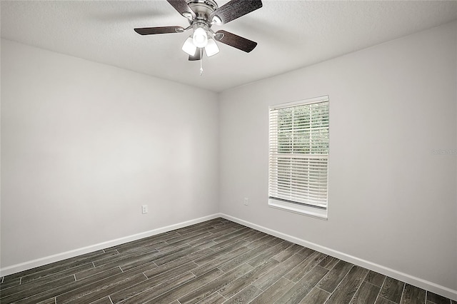 unfurnished room with a textured ceiling, ceiling fan, and dark wood-type flooring