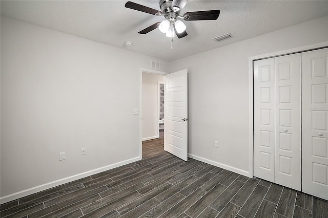 unfurnished bedroom featuring ceiling fan, a closet, and a textured ceiling