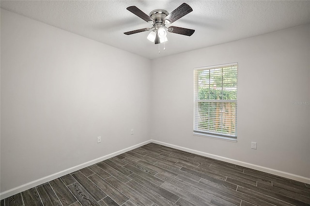 spare room with ceiling fan, dark wood-type flooring, and a textured ceiling