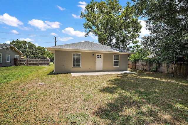 back of property featuring a yard and a patio