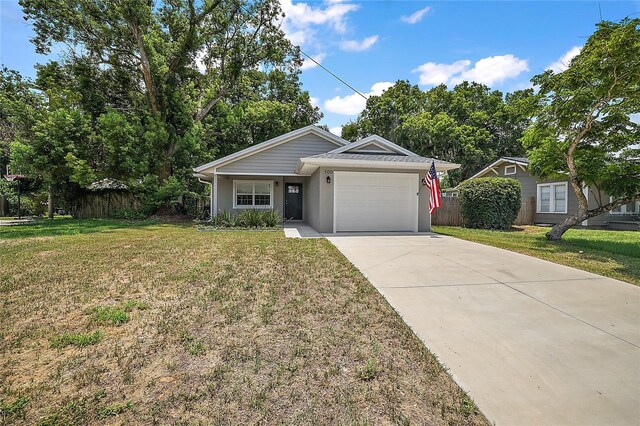 ranch-style house with a garage and a front yard