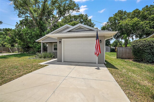 view of front of property featuring a front yard and a garage