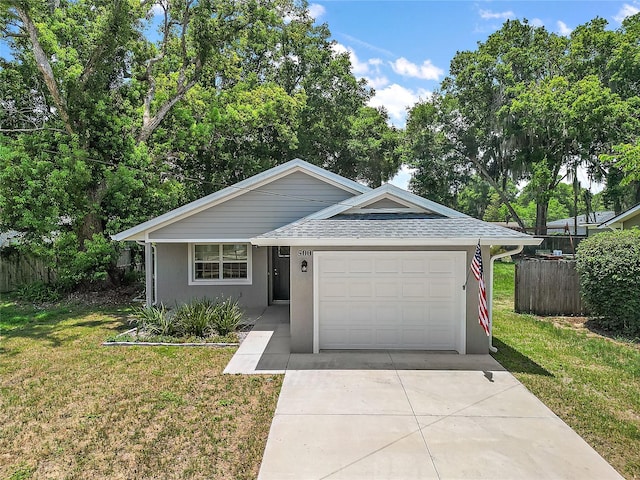 single story home with a garage and a front yard