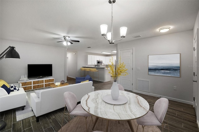 dining room with ceiling fan with notable chandelier