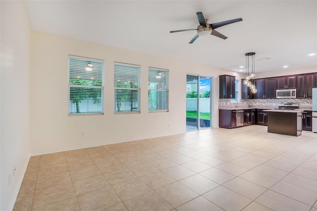 interior space with light tile patterned floors, sink, and ceiling fan