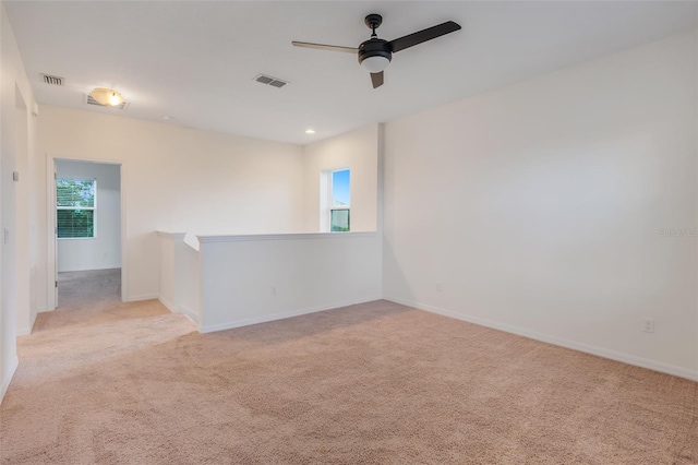 carpeted empty room with ceiling fan