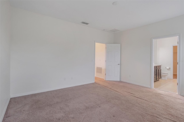 unfurnished room with light colored carpet