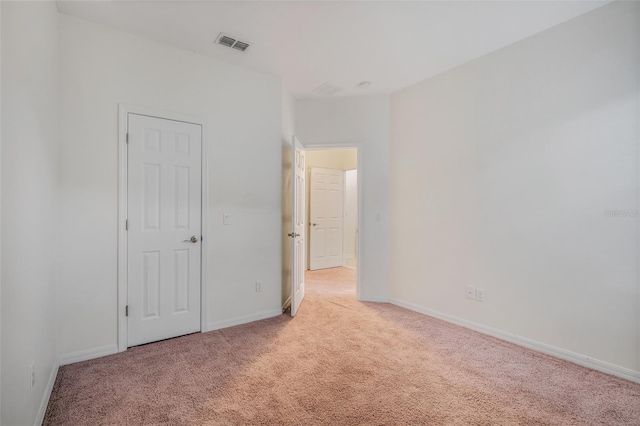 unfurnished bedroom featuring light carpet