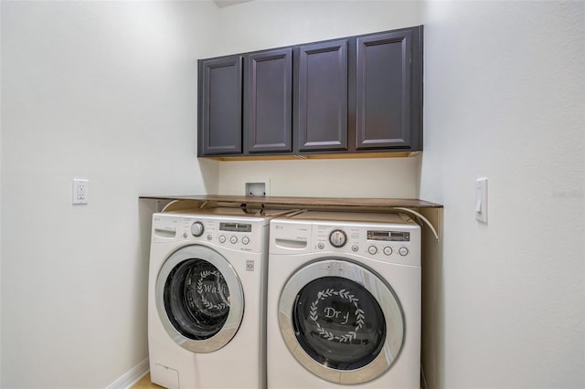 laundry room with cabinets and washer and dryer