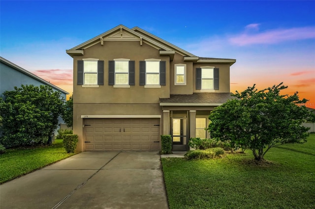 view of front of property featuring a garage and a lawn