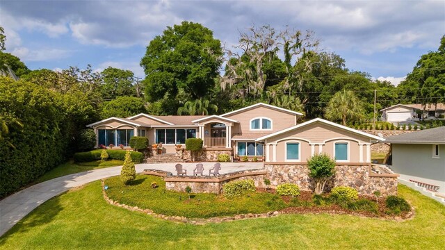 2537 E Crooked Lake Dr, Eustis, FL 32726 - view of front facade with stone siding and a front yard