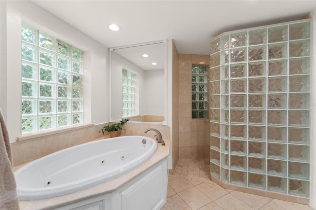 bathroom with tile patterned floors, a healthy amount of sunlight, and plus walk in shower