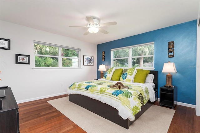 bedroom with ceiling fan and dark wood-type flooring