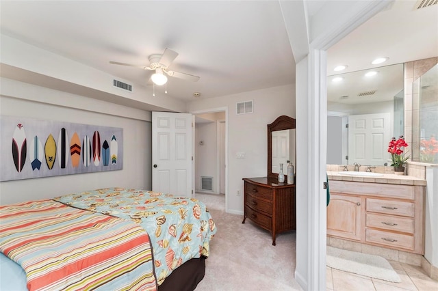 bedroom featuring ensuite bathroom, sink, ceiling fan, and light carpet