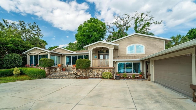 view of front of property featuring covered porch and a garage