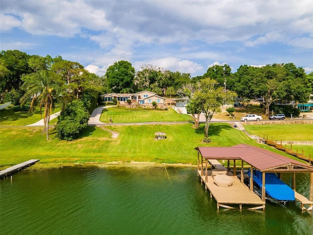 dock area featuring a water view and a yard