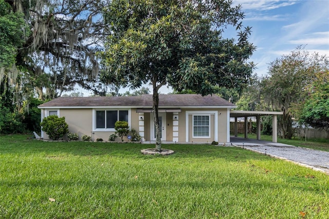 ranch-style house with a carport and a front lawn