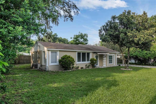 single story home featuring a front yard and central AC unit