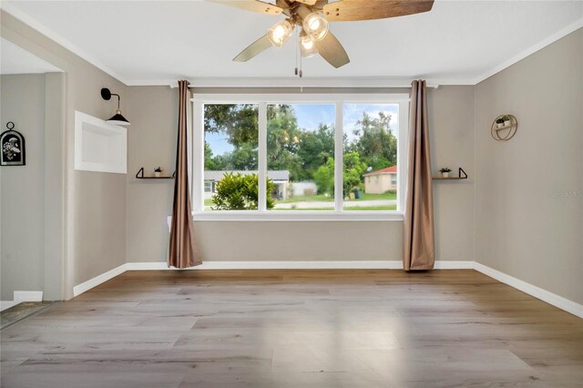 spare room featuring crown molding, ceiling fan, and light hardwood / wood-style floors