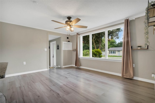 unfurnished living room featuring ceiling fan and wood-type flooring