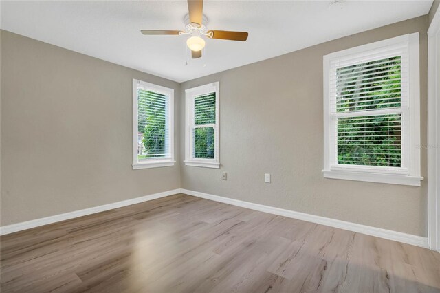 spare room featuring ceiling fan and hardwood / wood-style flooring