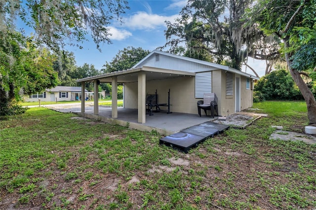 back of property with a patio and a yard