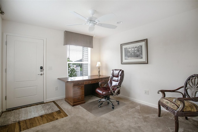 carpeted office featuring ceiling fan