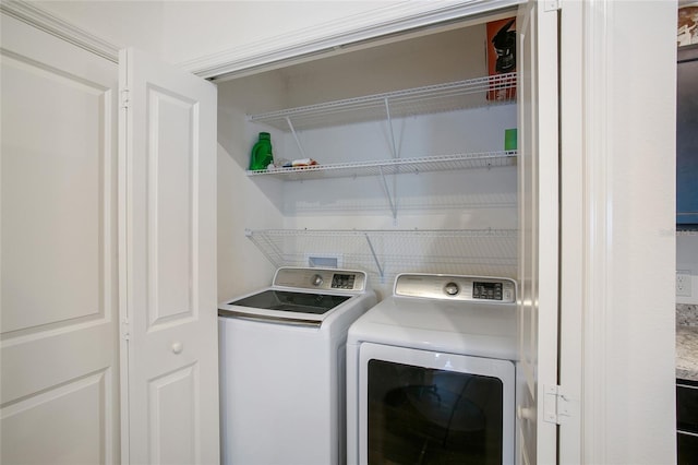 clothes washing area featuring washer and dryer