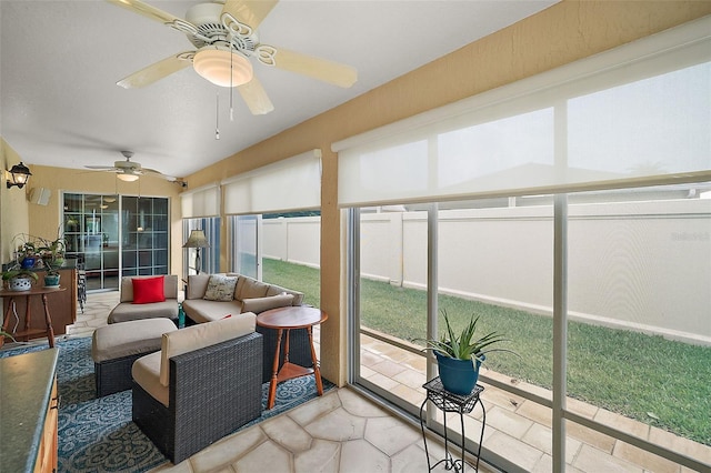 sunroom / solarium featuring ceiling fan